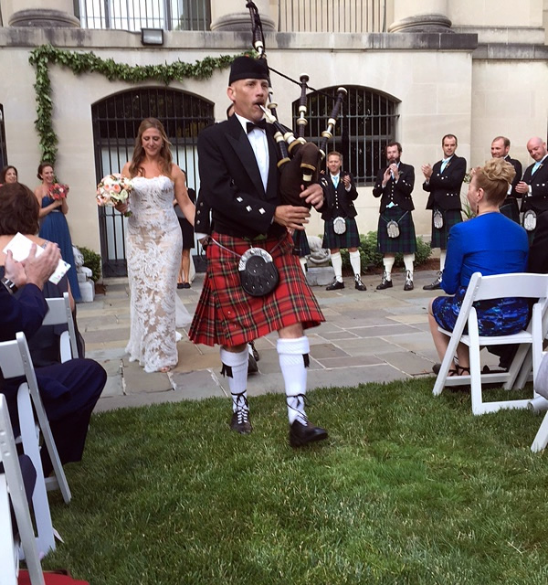 Bagpiper Paul Cora piping memorial music on his bagpipes at a Wedding at the Baltimore Museum of Art (BMA).